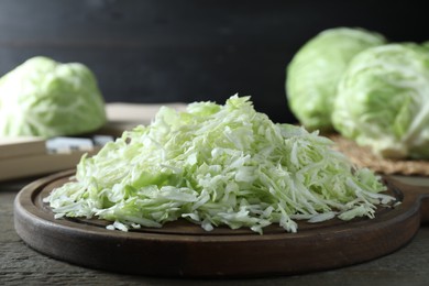 Fresh shredded cabbage on wooden table, closeup