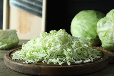 Fresh shredded cabbage on wooden table, closeup