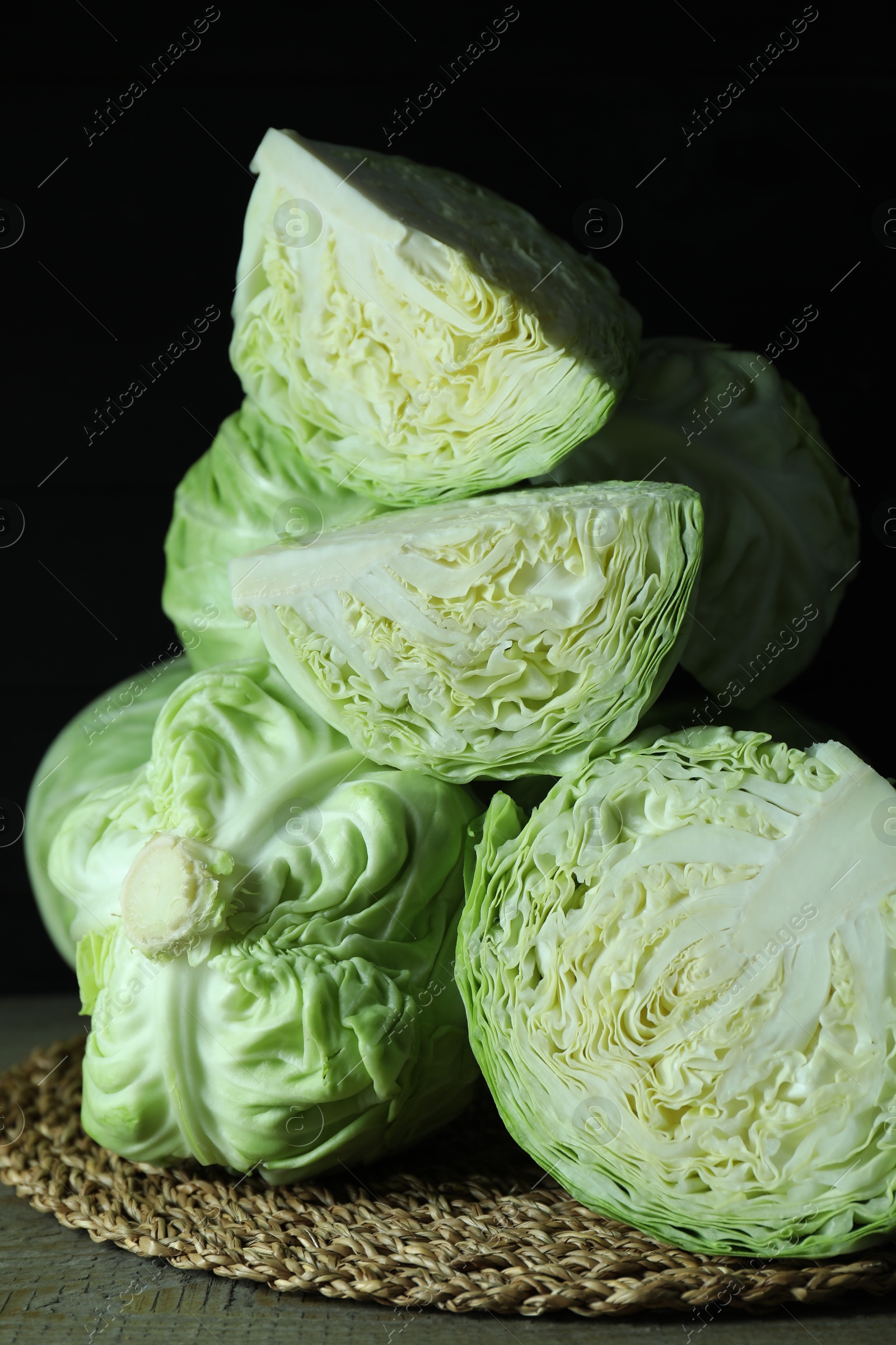 Photo of Whole and cut fresh cabbages on wooden table