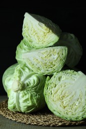 Photo of Whole and cut fresh cabbages on wooden table