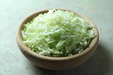 Photo of Fresh shredded cabbage on light table, closeup