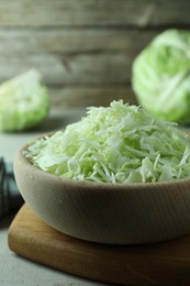 Photo of Fresh shredded cabbage on light table, closeup