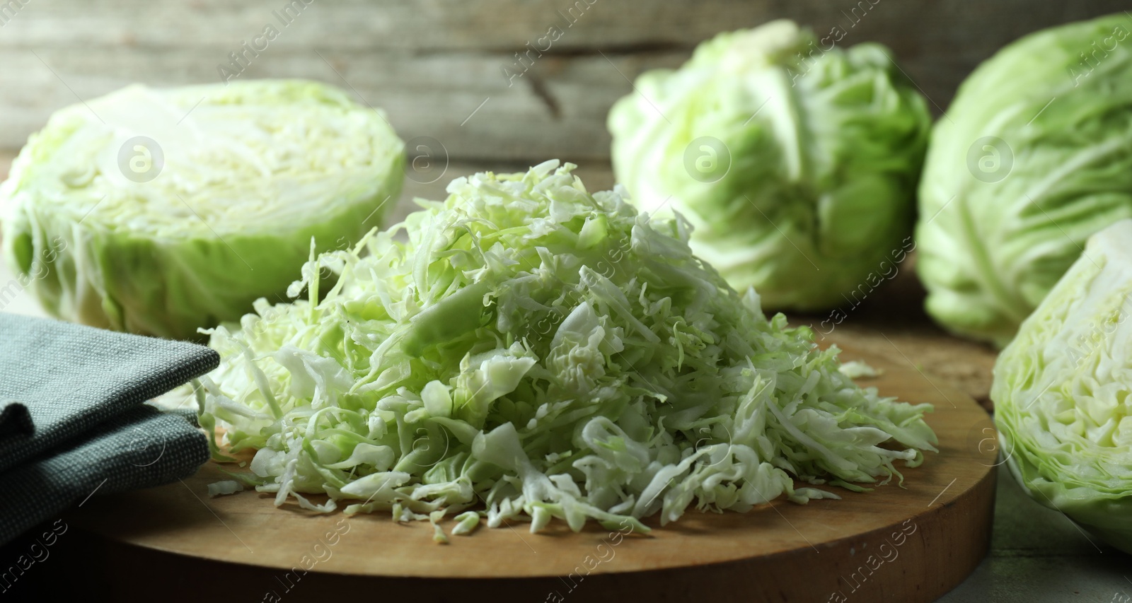 Photo of Fresh shredded cabbage on light table, closeup