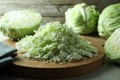 Photo of Fresh shredded cabbage on light table, closeup