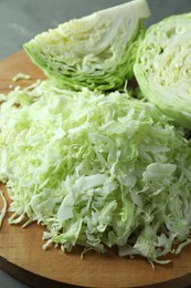 Photo of Fresh shredded cabbage on grey table, closeup