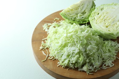 Photo of Fresh shredded cabbage on light table, closeup