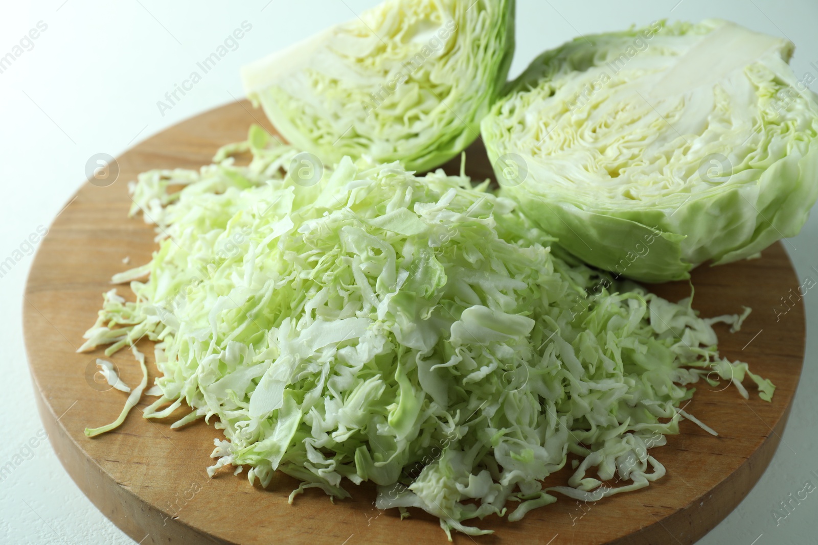 Photo of Fresh shredded cabbage on light table, closeup