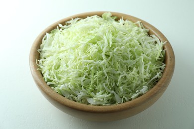 Photo of Fresh shredded cabbage on light table, closeup