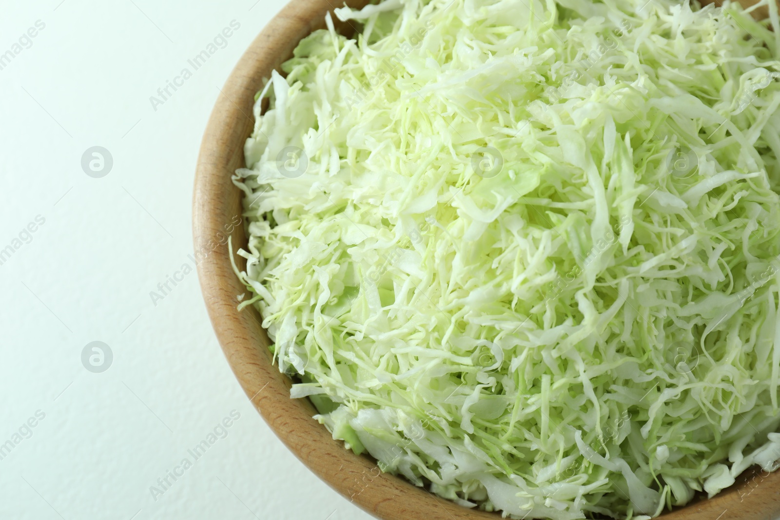 Photo of Fresh shredded cabbage on light table, top view