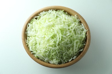 Photo of Fresh shredded cabbage on light table, top view