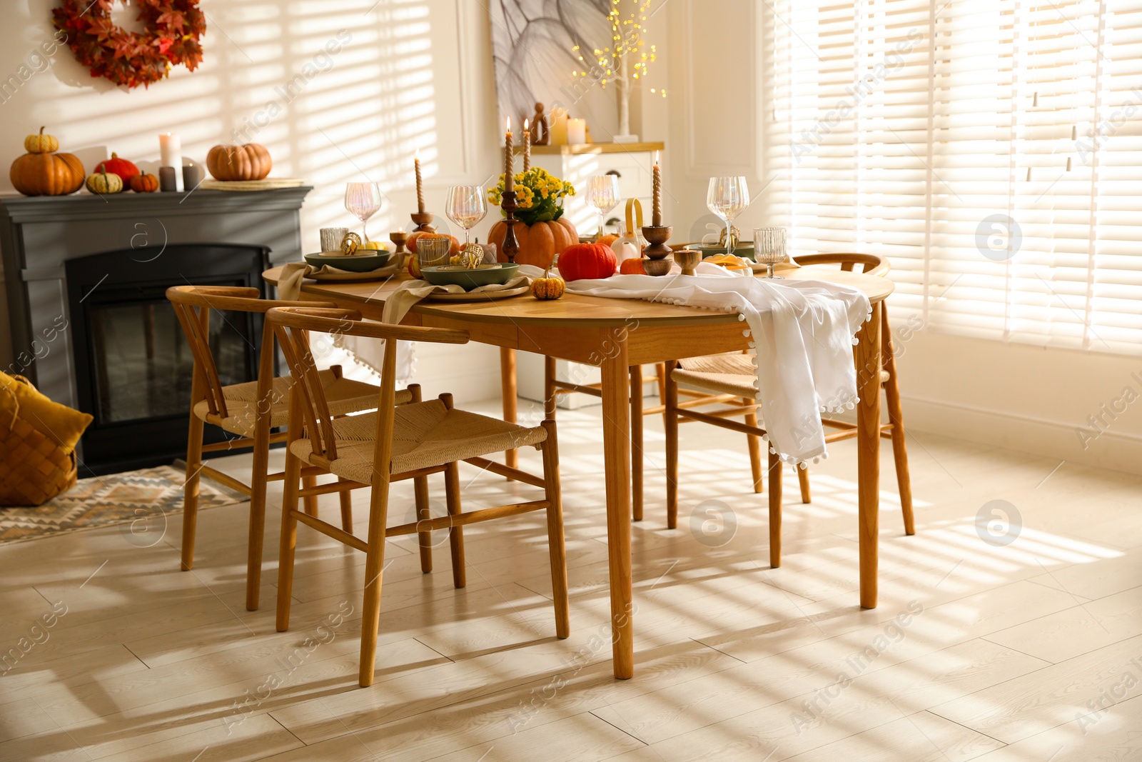 Photo of Stylish dining room with beautiful table setting and autumn decor