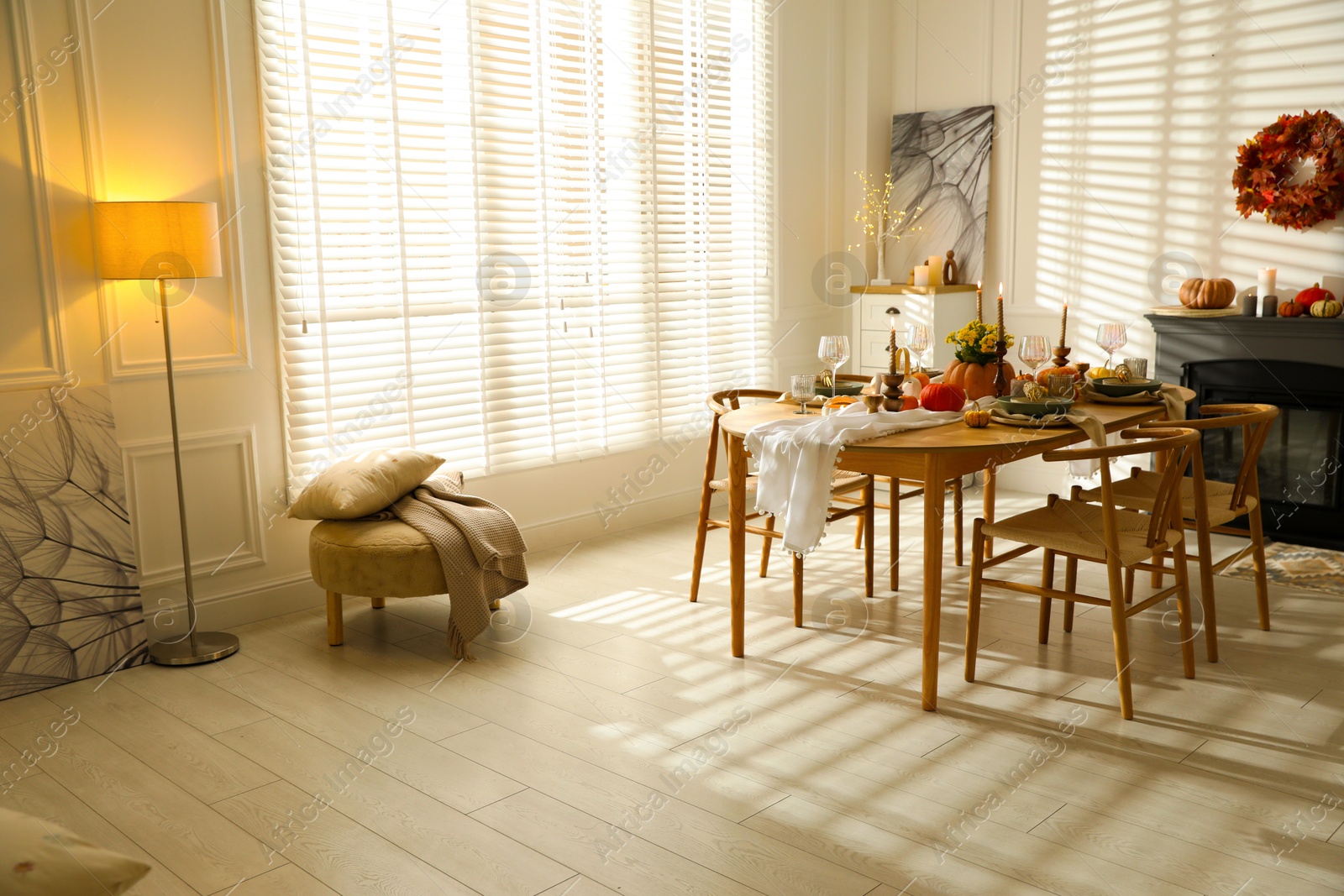 Photo of Stylish dining room with beautiful table setting and autumn decor