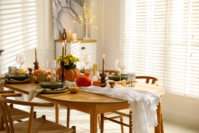 Stylish dining room with beautiful table setting and autumn decor