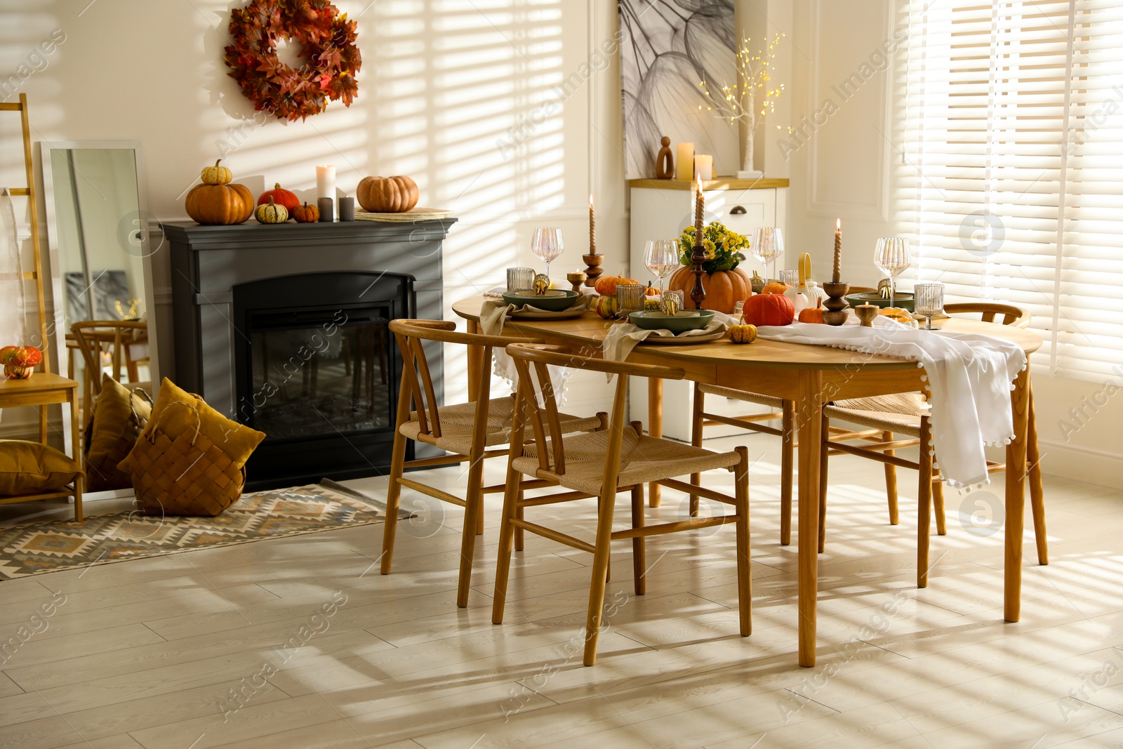 Photo of Stylish dining room with beautiful table setting and autumn decor