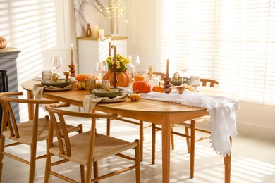 Stylish dining room with beautiful table setting and autumn decor