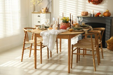 Stylish dining room with beautiful table setting and autumn decor