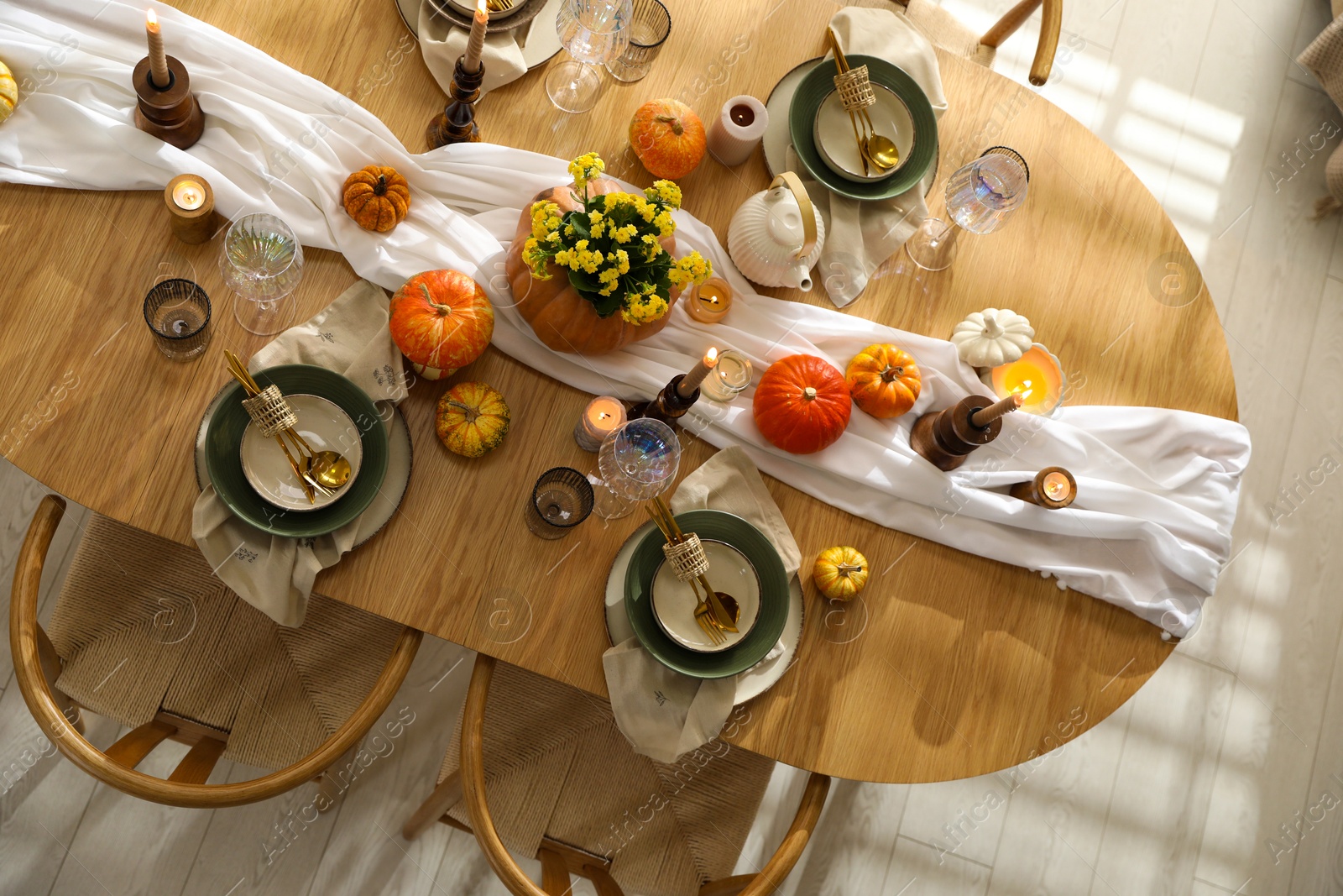 Photo of Stylish table setting with beautiful dishware, glasses and autumn decor in dining room, top view