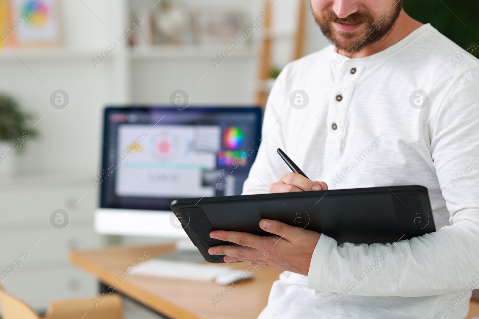 Photo of Designer working with tablet in office, closeup