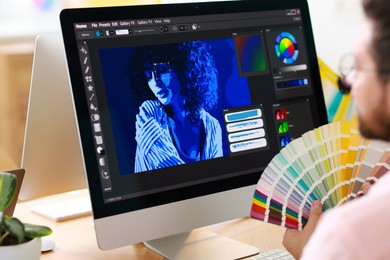 Designer working at table in office, closeup