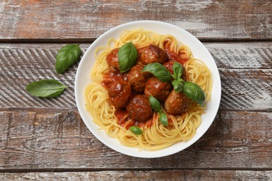 Delicious pasta with meatballs on wooden table, top view