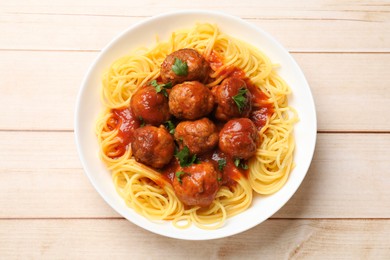 Photo of Delicious pasta with meatballs on white wooden table, top view