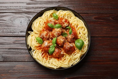 Delicious pasta with meatballs on wooden table, top view