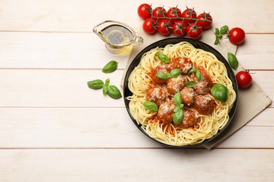 Photo of Delicious pasta with meatballs and ingredients on wooden table, flat lay. Space for text