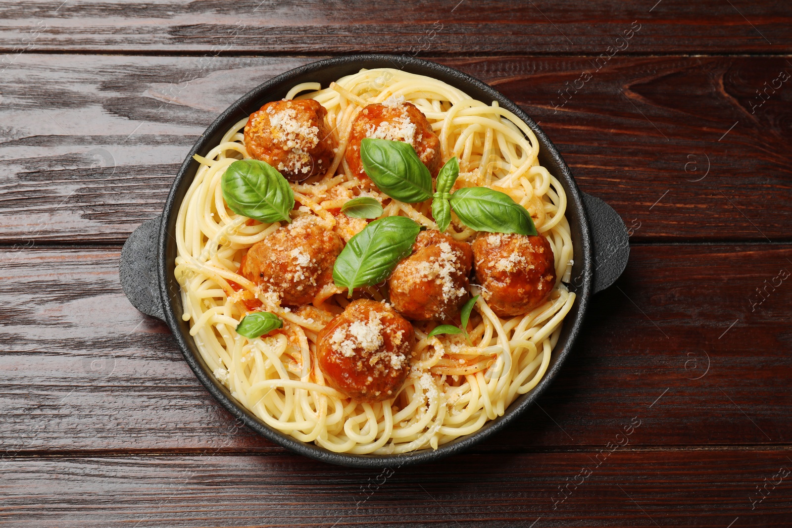 Photo of Delicious pasta with meatballs on wooden table, top view