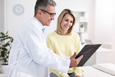 Healthcare worker with clipboard and patient in hospital