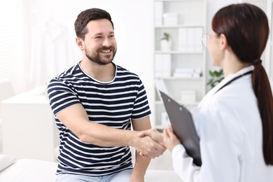 Photo of Healthcare worker shaking hands with patient in hospital