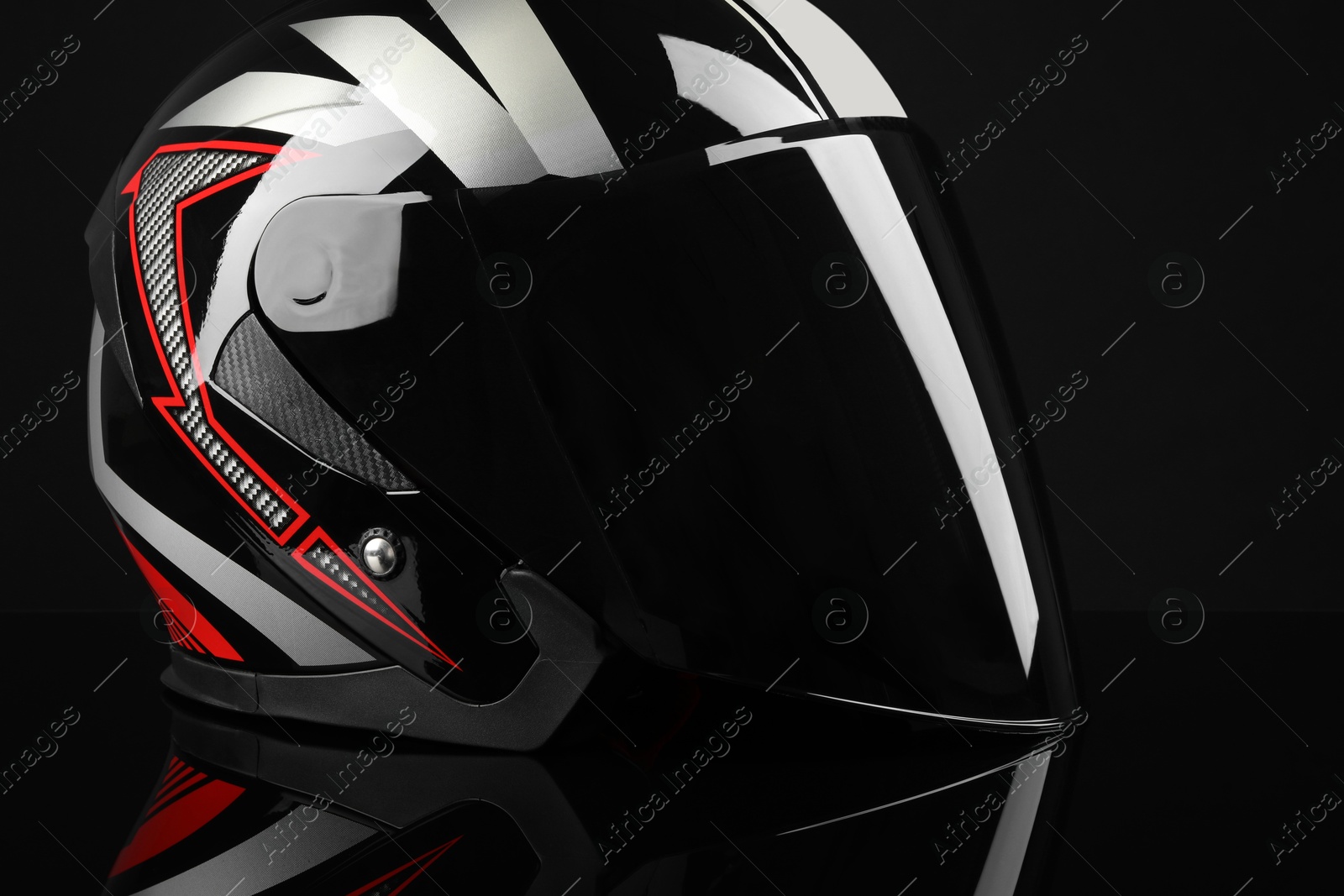 Photo of Motorcycle helmet with visor on black background, closeup