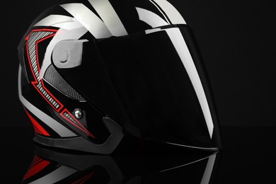 Photo of Motorcycle helmet with visor on black background, closeup