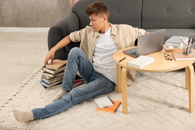 Student with books studying on floor at home