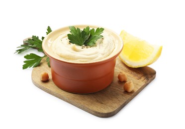 Photo of Delicious hummus with chickpeas, parsley and lemon isolated on white