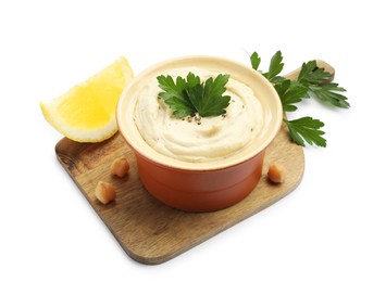 Photo of Delicious hummus with chickpeas, parsley and lemon isolated on white