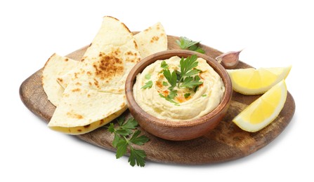 Photo of Delicious hummus with parsley, paprika, pita and lemon isolated on white