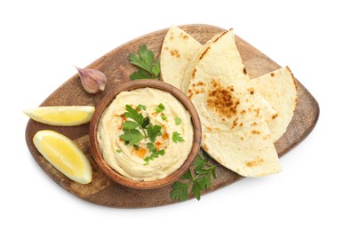 Delicious hummus with parsley, paprika, pita and lemon isolated on white, top view