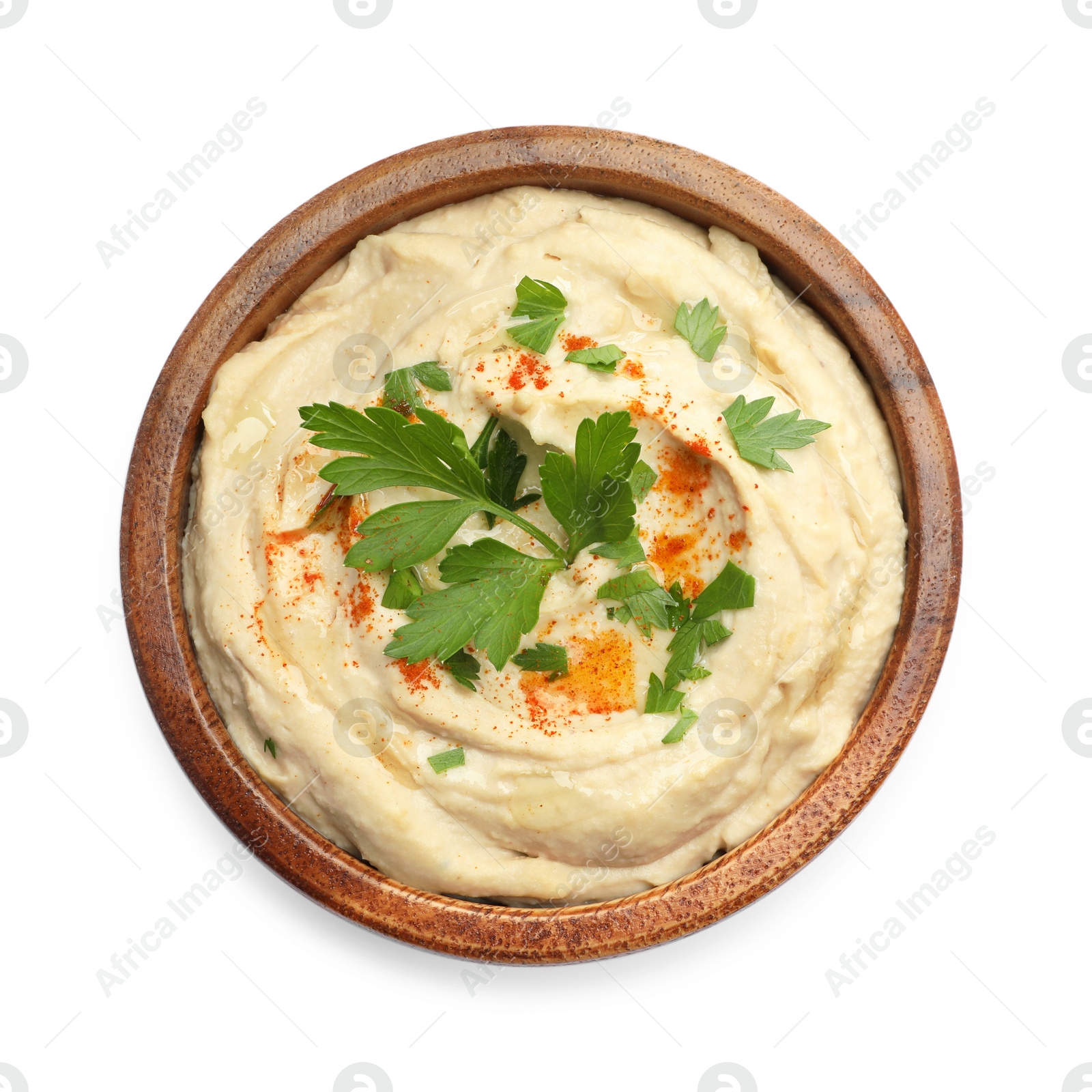 Photo of Delicious hummus with paprika and parsley in bowl isolated on white, top view