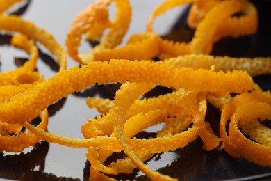 Photo of Pile of fresh orange zest on plate, closeup