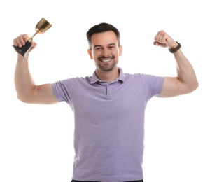 Photo of Happy winner with golden trophy cup showing his biceps on white background