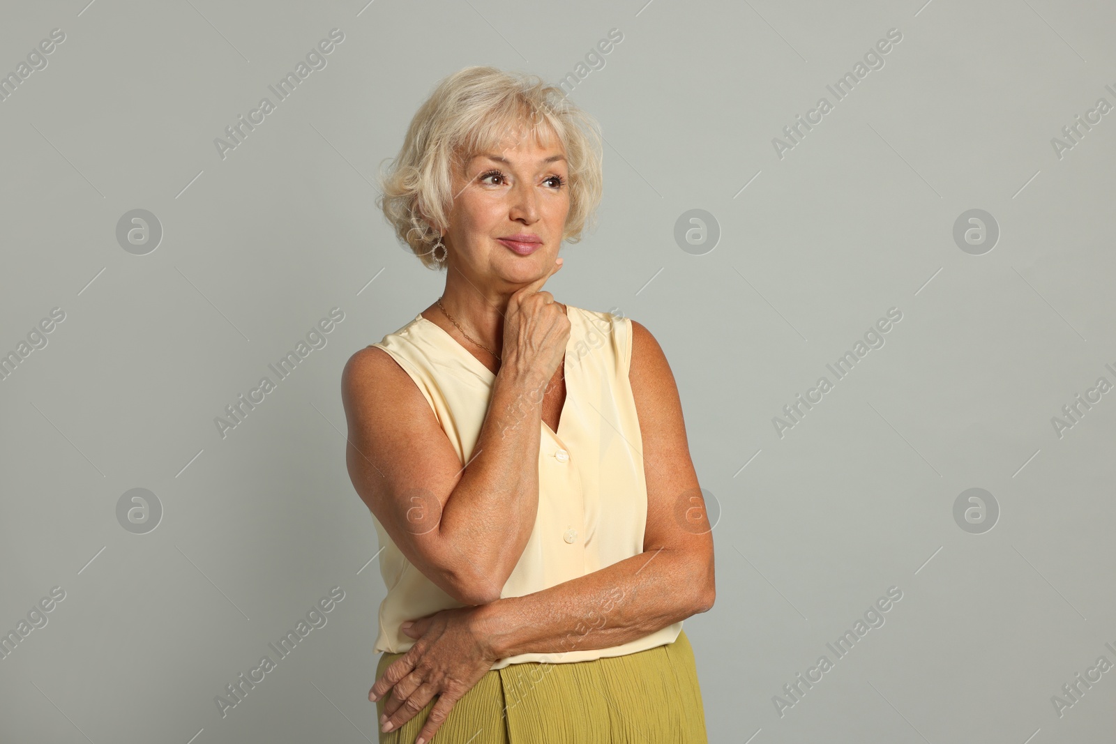 Photo of Portrait of beautiful senior woman on light grey background