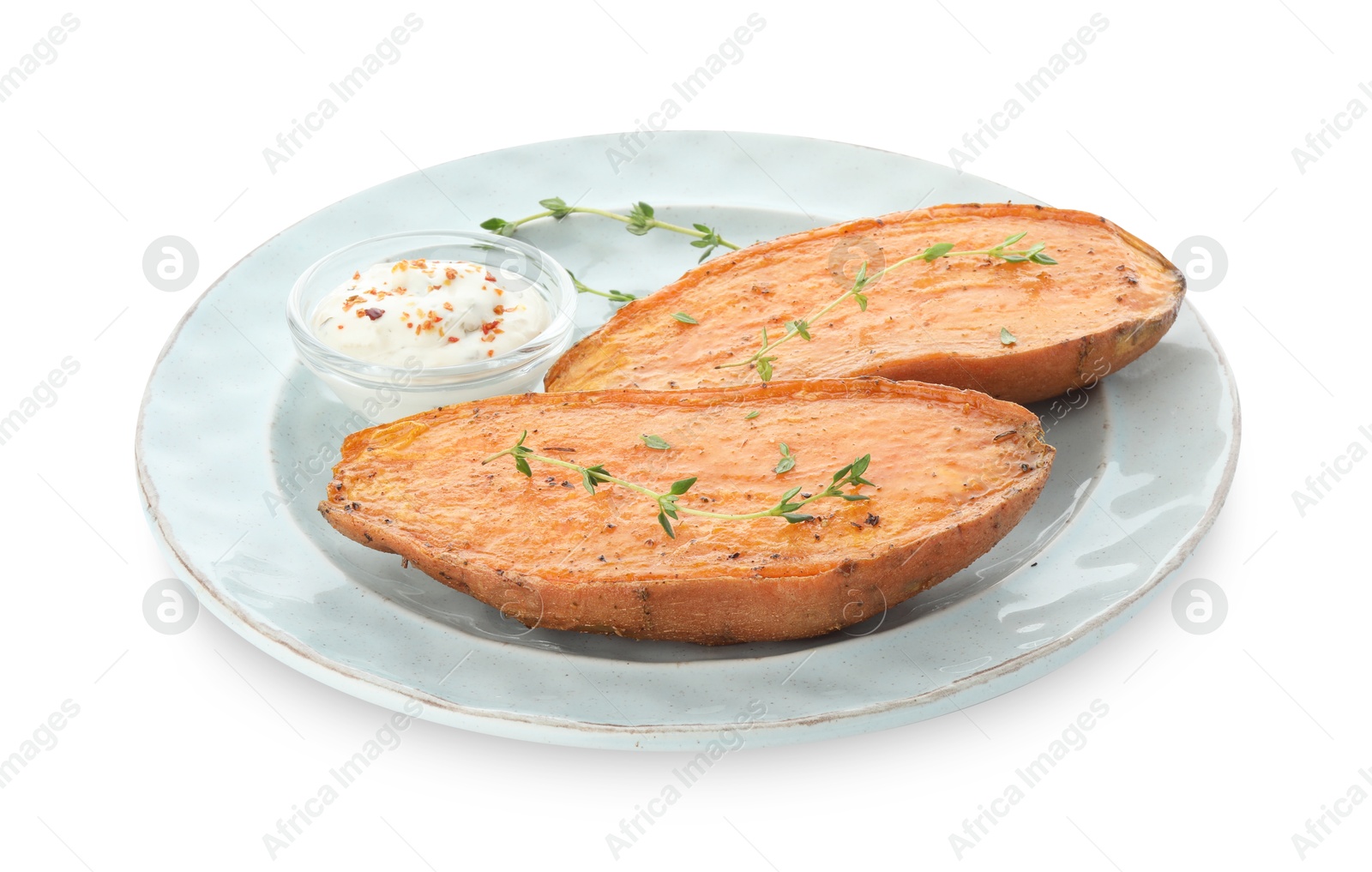 Photo of Halves of tasty cooked sweet potato with thyme and sauce isolated on white