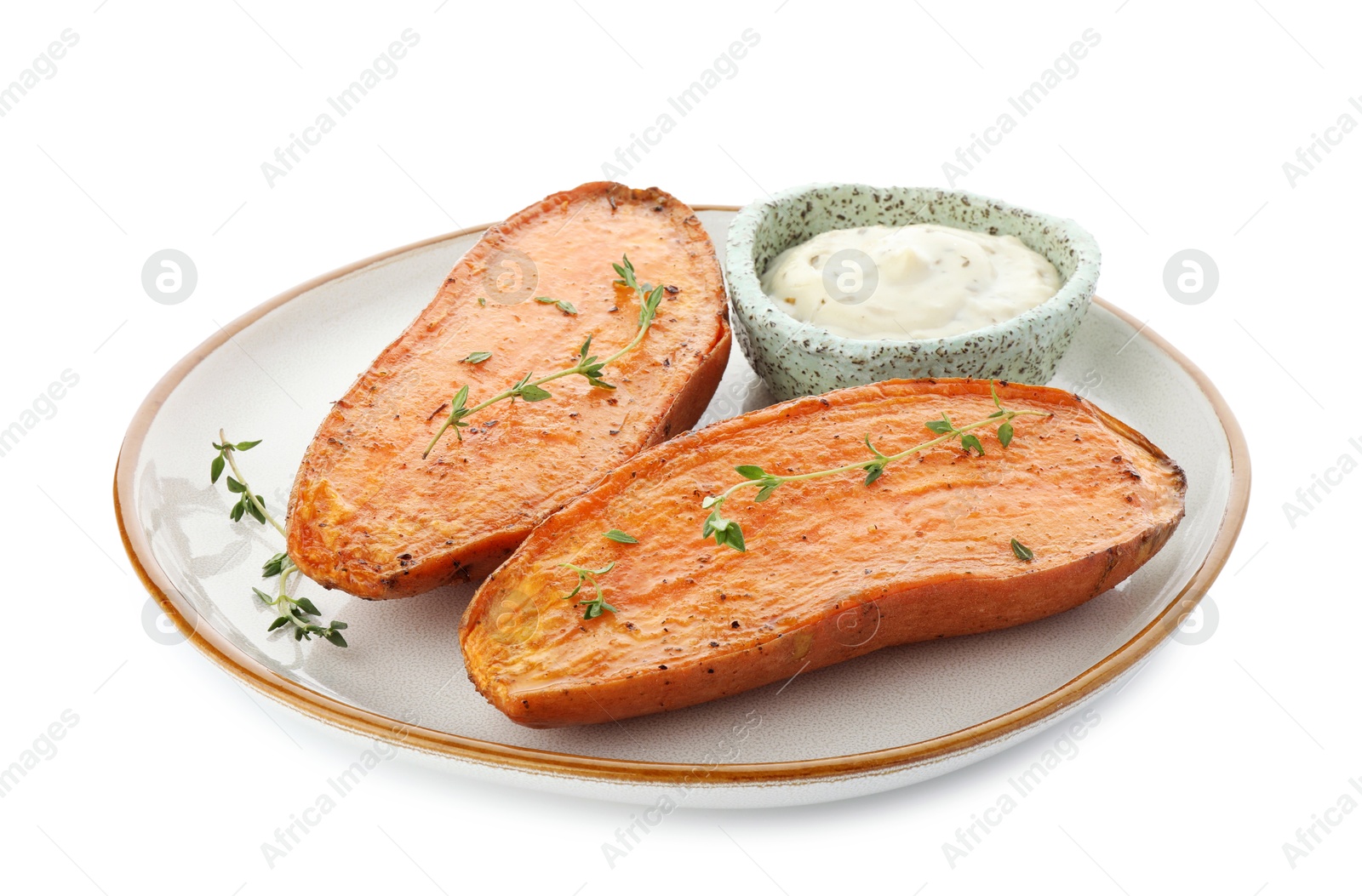 Photo of Halves of tasty cooked sweet potato with thyme and sauce isolated on white