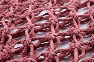 Photo of Handmade macrame shopping bag on white background, closeup