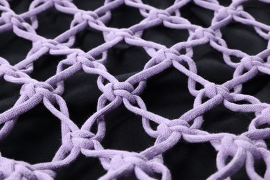 Photo of Handmade macrame shopping bag as background, closeup