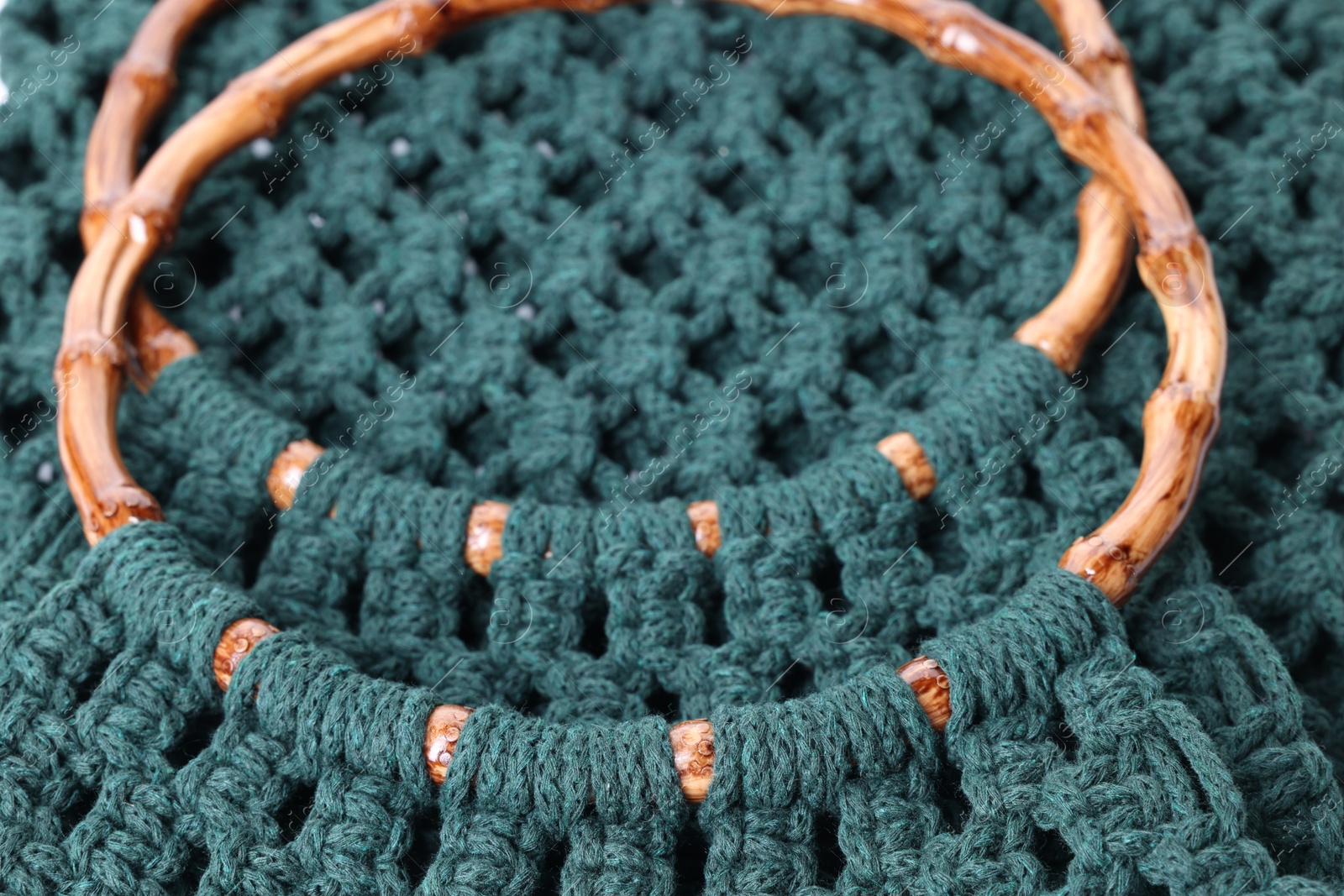 Photo of Handmade macrame shopping bag as background, closeup