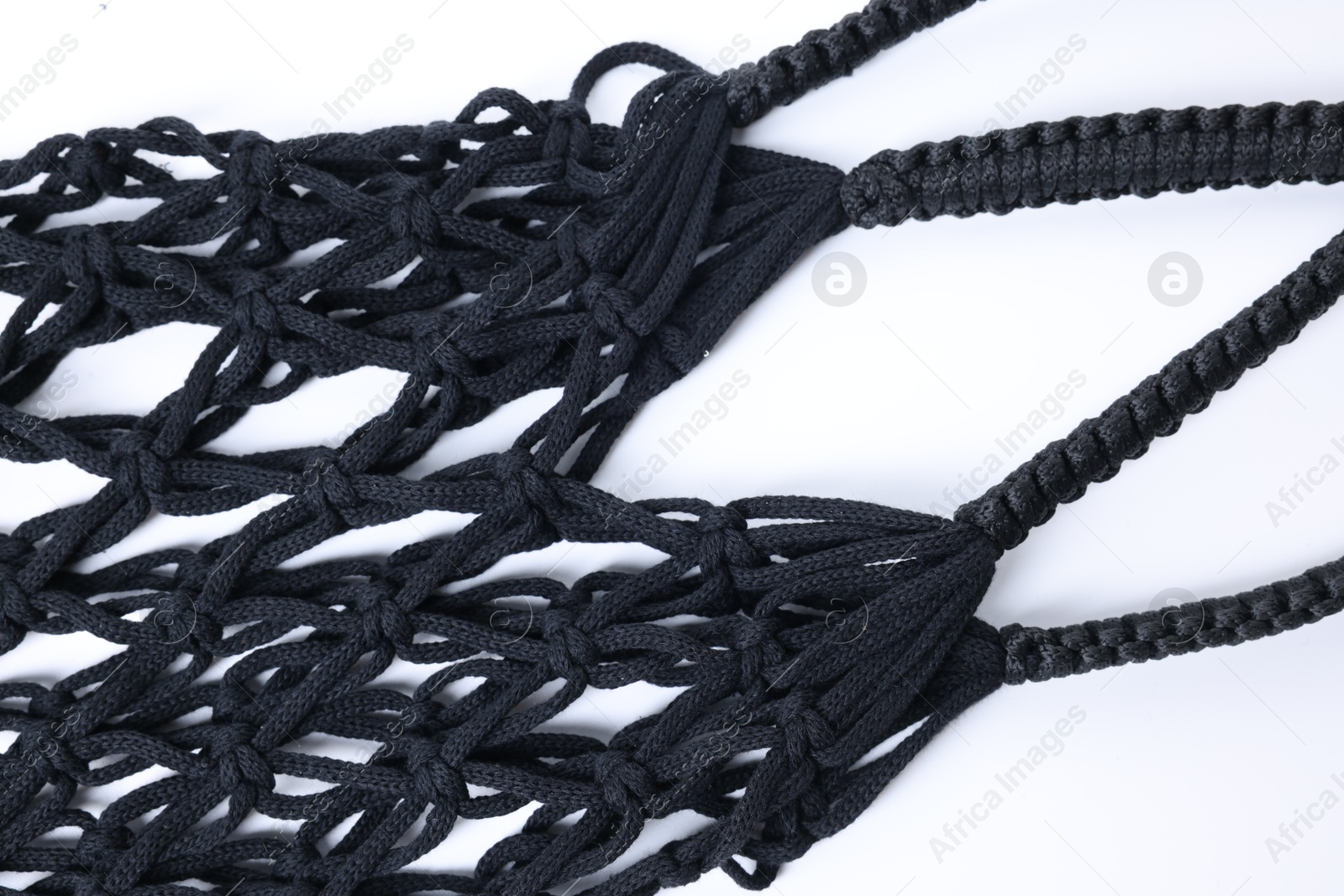 Photo of Handmade macrame shopping bag on white background, closeup