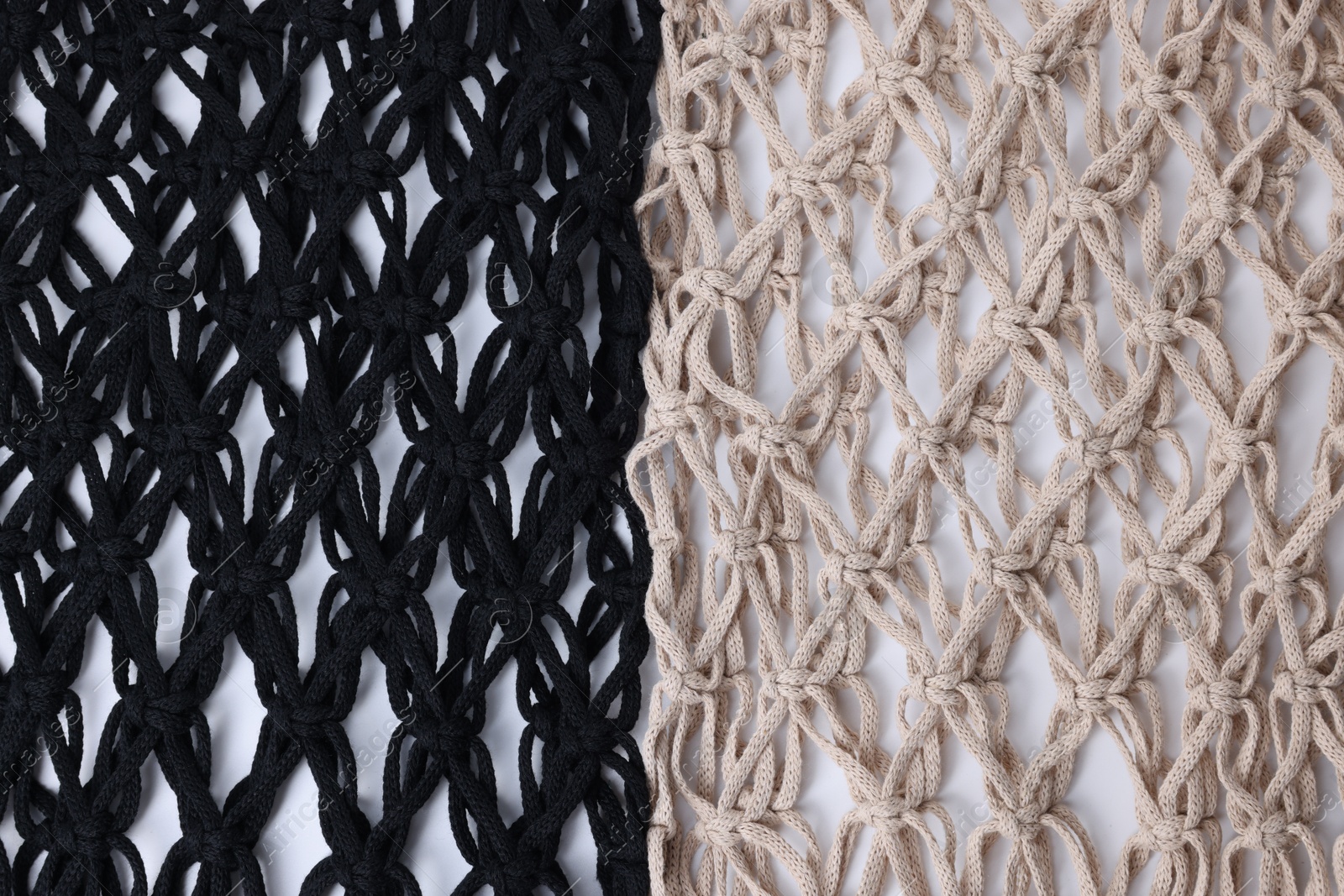 Photo of Two macrame shopping bags on white background, closeup