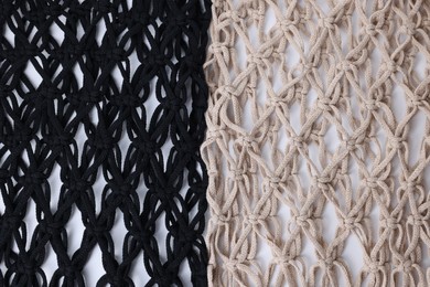 Photo of Two macrame shopping bags on white background, closeup