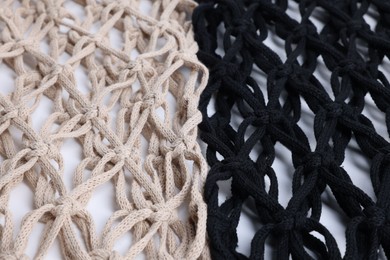 Photo of Two macrame shopping bags on white background, closeup